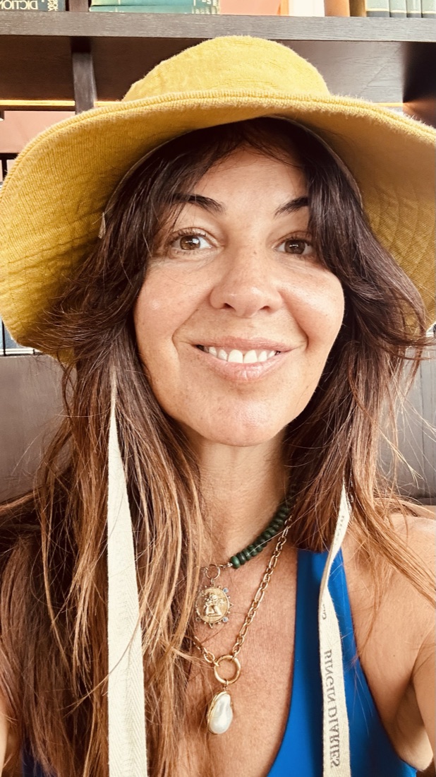 Rocha smiling in a yellow sun hat